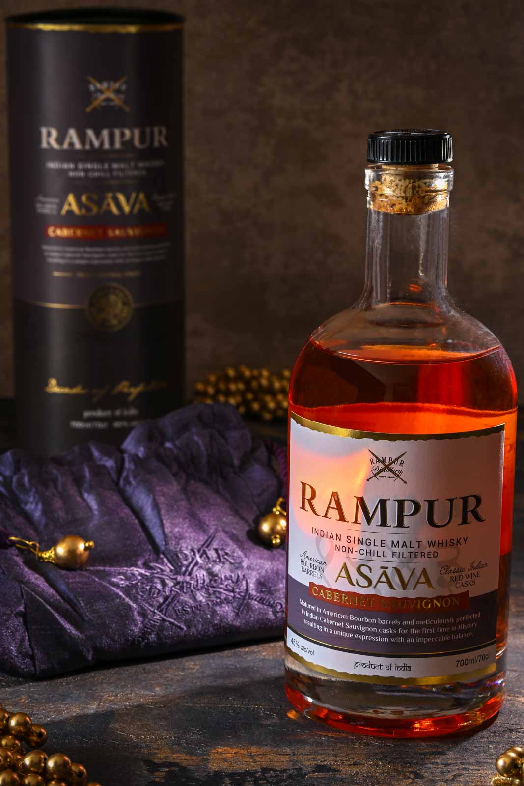 Rampur whiskey backlit with gold and purple silk pouch